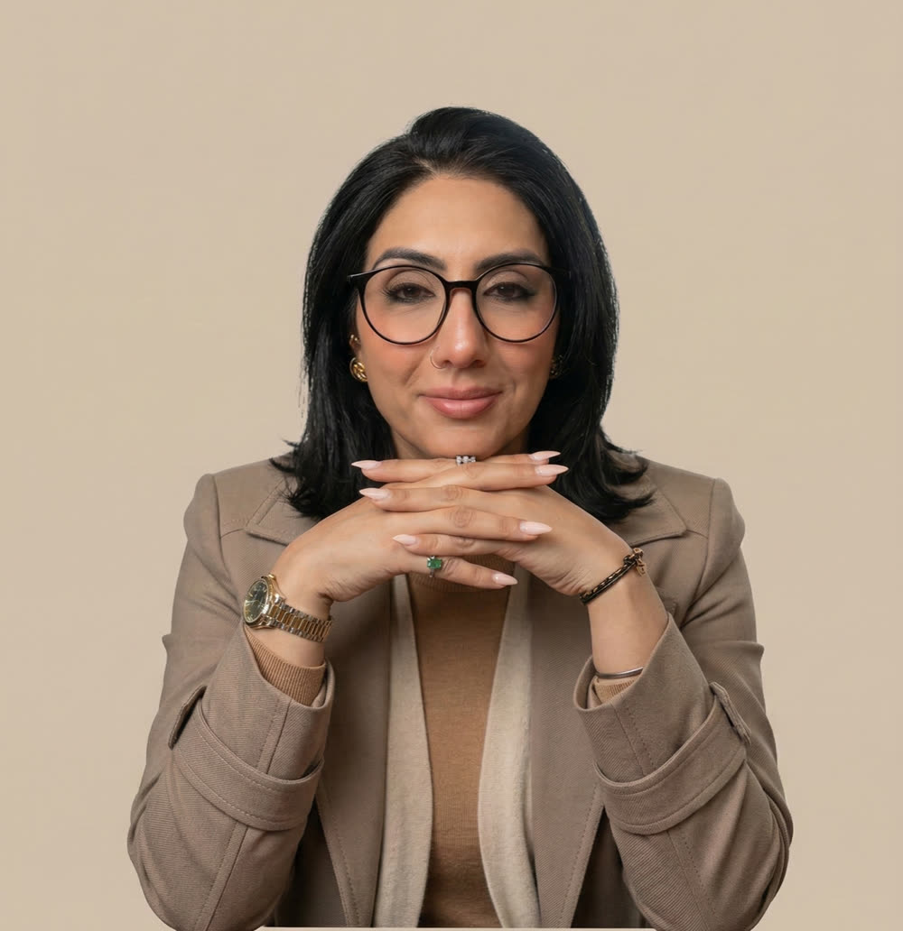 Rubina K. Singh, LCSW, smiling, hands folded under her chin